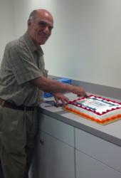 Dr. Matthew Mashikian, founder of IMCORP, cuts the cake